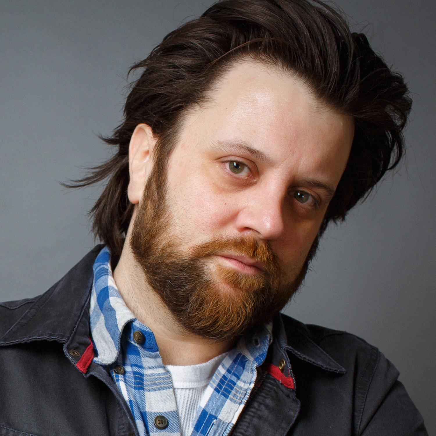 A portrait oof a white man with a beard