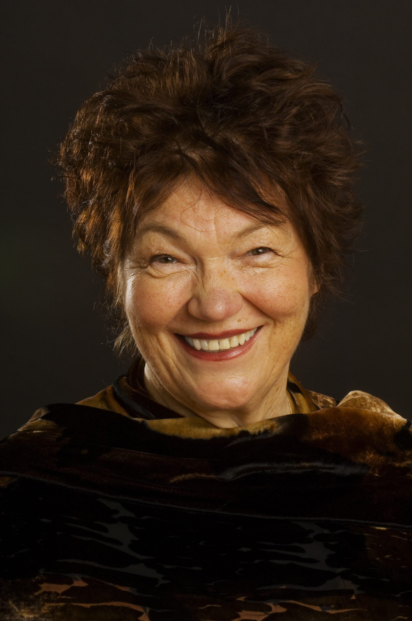 headshot of a woman with short red hair smiling
